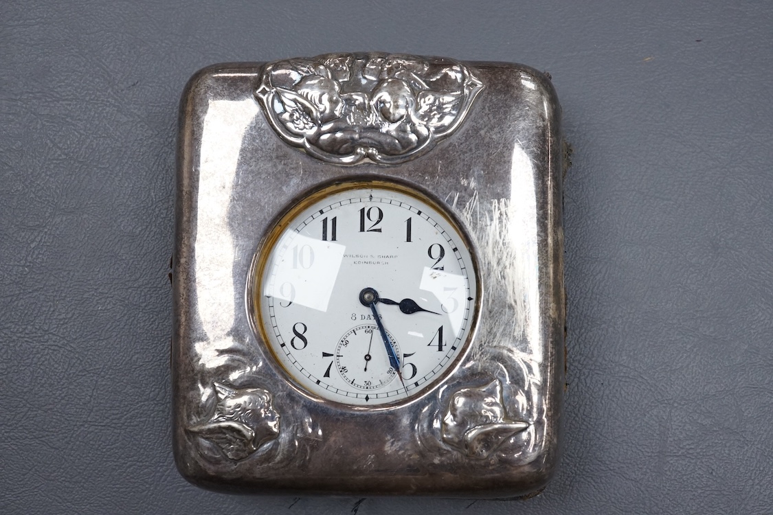 An Edwardian silver mounted travelling watch case, by William Comyns, London, 1903, width 10.2cm, containing a chrome cased pocket watch retailed by Wilson & Sharp.